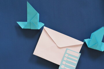 Two birds paper origami carrying letter envelope. Receiving email or mail such as survey form concept. - obrazy, fototapety, plakaty