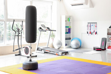 Interior of gym with different modern sports equipment