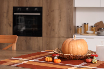 Pumpkins with mushrooms on table in modern kitchen