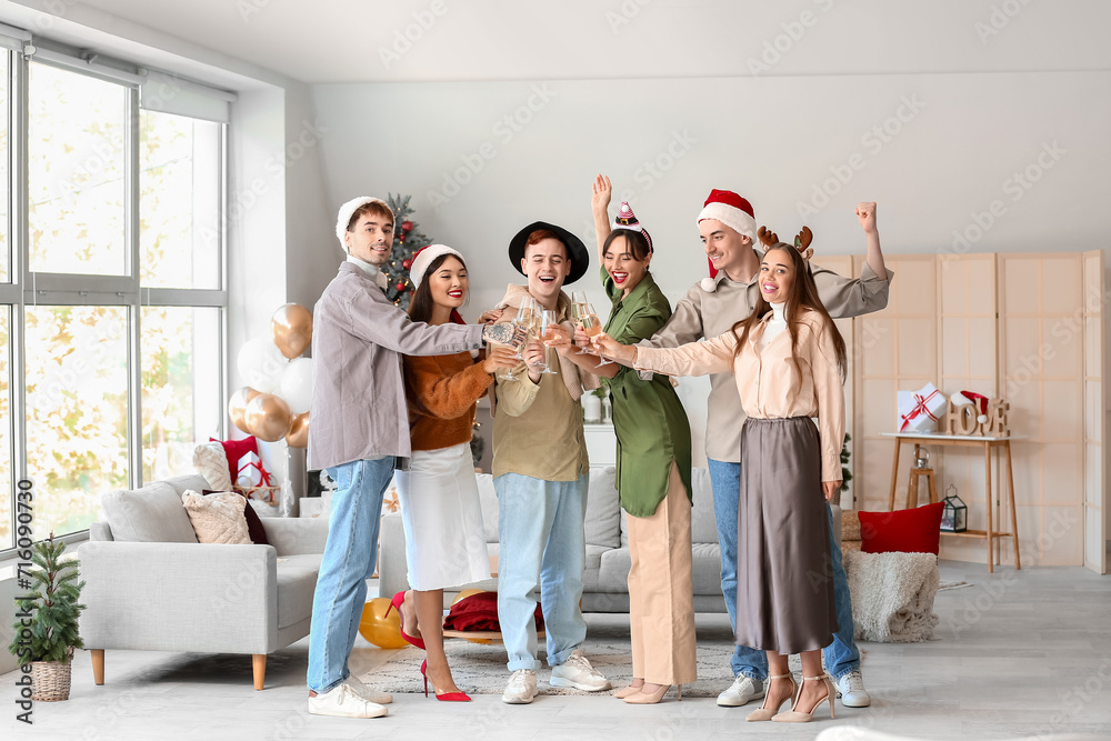 Poster Group of friends with champagne celebrating New Year at home party