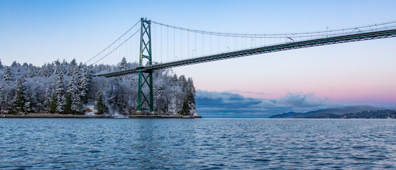 Lions Gate Bridge in Stanley Park, Downtown Vancouver. Snow Covered Winter Sunrise