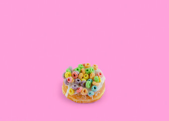 Pink donut on a pink background with copy space