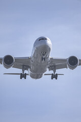 Naklejka premium View of the underside of the fuselage of a passenger plane at low altitude near the runway