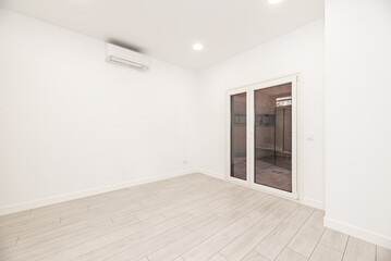 Fototapeta na wymiar An empty white room in a loft-style home with an aluminum and glass