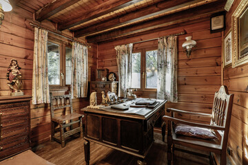 An office of old wooden furniture inside a wooden cabin