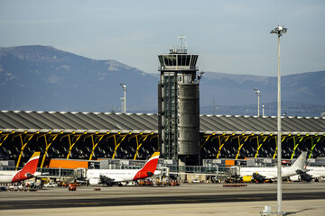Airport control tower next to a terminal - obrazy, fototapety, plakaty