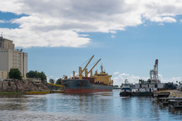 Large cargo ship being loaded with goods at the main port of Santo Domingo, Dominican Republic.