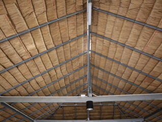 Roofs made from grass hay and Steel Structures © Phetmanee