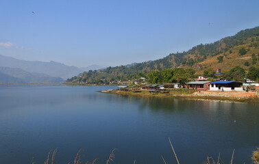 Fototapeta premium Beautiful morning around Phewa lek in Pokhara. Blue sky, clear water, clouds and landscape.