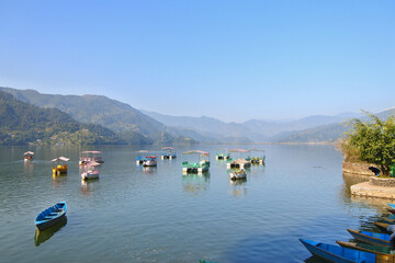Beautiful morning around Phewa lek in Pokhara. Blue sky, clear water, clouds and landscape.