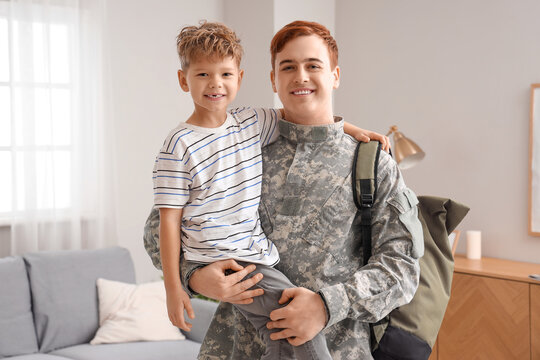Little boy with his military father at home