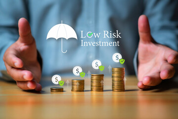Low risk investments. Businessman saving  money with shield icon and word low risk investment, Business and financials concept.