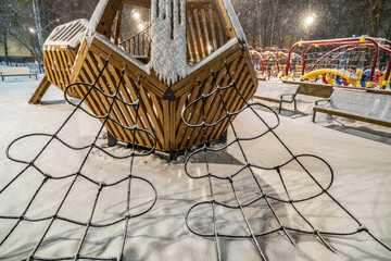 Children's playground on a winter evening in the park.