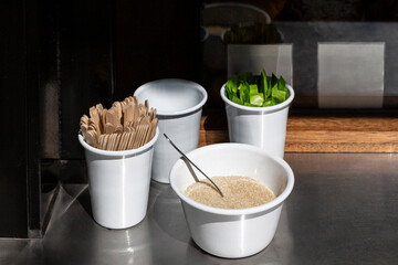 Wooden Stir Sticks, and Sugar Arranged on the Counter