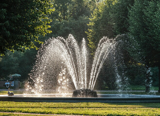 A working fountain in the park on a summer day.