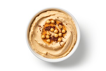 Top down view of homemade hummus in a white bowl isolated