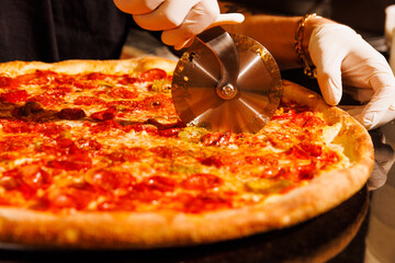 Cutting into a fresh New York pizza