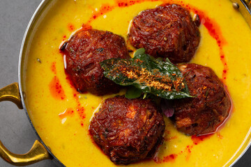 Chickpea balls on curry dish