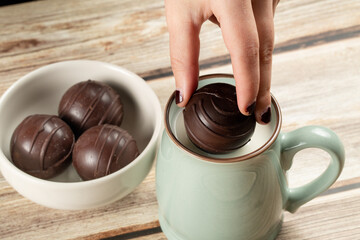 Dropping hot chocolate ball into milk