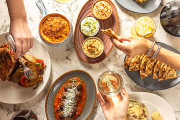 Friends sharing greek dishes