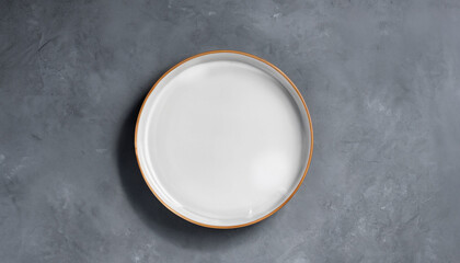 Porcelain handmade empty round a plate on a gray concrete background with a copy of space. Can be used for display or montage your products. Flat lay. High quality photo