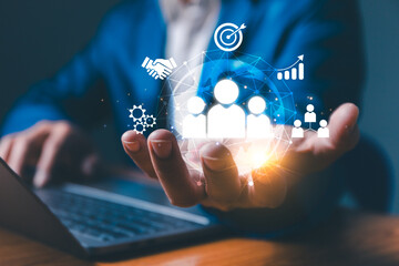 Employing CRM, the businessman manages global customer networks, leveraging technology for data...