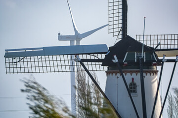 Traditional windmill and wind turbine juxtaposed in one image.