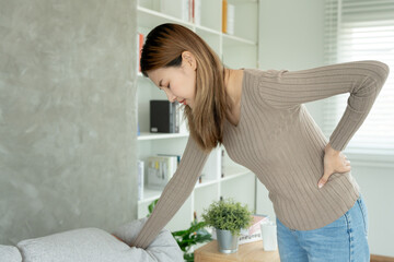 Asia beautiful woman holding her lower back while and suffer from unbearable pain health and...