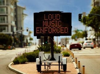 Digital sign stating Loud  Music Enforced in an urban area in attempt to reduce loud music from...