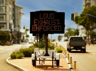 Fotobehang Digital sign stating Loud Exhaust Enforced in attempt to reduce loud car noise © F Armstrong Photo