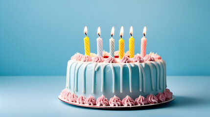 Birthday cake with colorful candles on blue background.