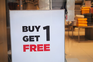 Buy one get one free label on a blur Supermarket background