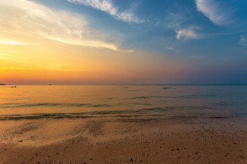 Beautiful summer beach and sea and yellow orange sky at the sunset, twilight period which including...