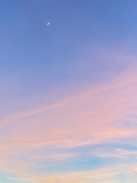Pinky and blue sky with moon during sunset