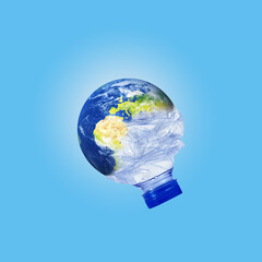 world environment day and earth day concept. Globe in crumpled plastic bottle on isolated blue background. Climate change and Global warming concept.beat plastic pollution
