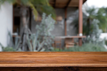 Wood table space over blur background of cafe restaurant.