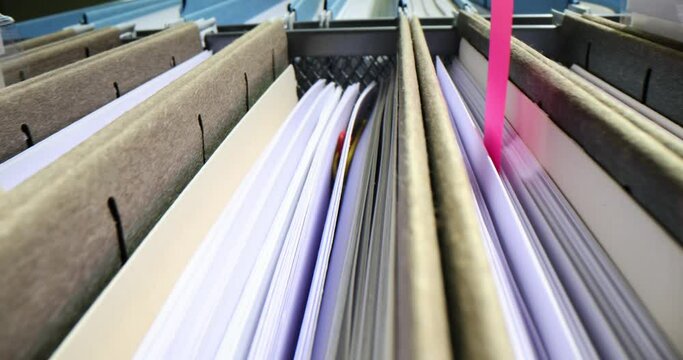 Business folders with personal documents in drawer