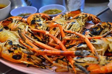 Grilled Giant River Prawn set in the plate for eating. It is a food menu that tourists love when they go to eat Thai-style seafood.