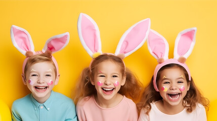 Obraz na płótnie Canvas Happy children in bunny ears celebrating easter