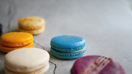 Fancy color macaroons, French snack, pastry recipe, almond flour, colorful macarons minimal composition, trendy on grey background, selective focus