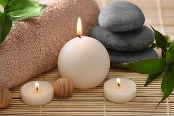 Spa stones, towel and candles, closeup