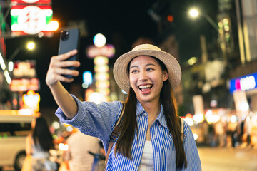 Traveler asian young woman using smart phone camera to take photo, selfie or video call at china town in Bangkok. Backpacker travel on holiday trip or vacation concept - 716223344