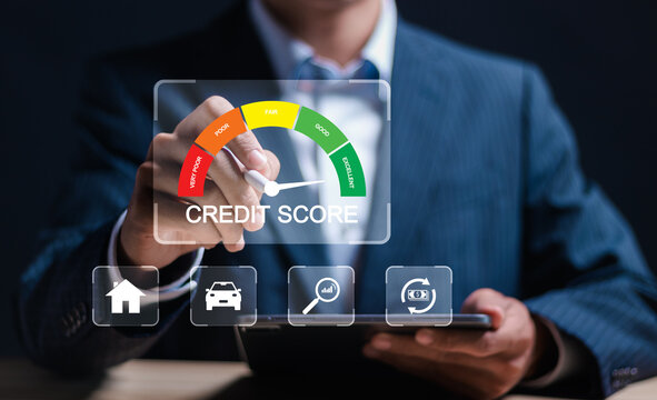 Credit score concept, Businessman use tablet with virtual credit score icon for chart with credit history values. Online credit score ranking check. student loan, mortgage and payment cards.