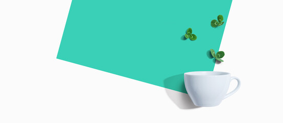 Shamrock leaves with coffee cup - flat lay