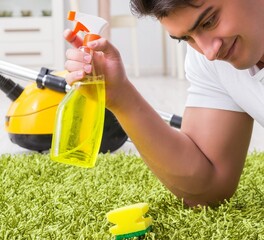 Young husband man cleaning floor at home