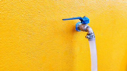 Closeup faucet on concrete wall background. A wall tap on a wall. Water faucet with faucet...