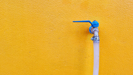 Closeup faucet on concrete wall background. A wall tap on a wall. Water faucet with faucet...