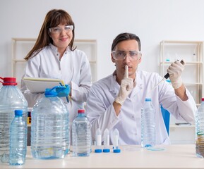 Two chemists working in the lab