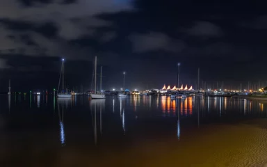 Fotobehang Lights and reflections across the Broadwater at night with yachts and the marina with its iconic sail shaped roof on the Gold Coast , a popular tourist destination in Queensland, Australia. © Shirley and Johan