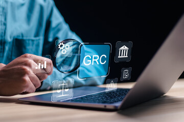 Boost efficiency with GRC Governance Risk and Compliance. Businessman use laptop with GRC icon on digital screen, structuring to align IT with business goals for optimal performance. - obrazy, fototapety, plakaty